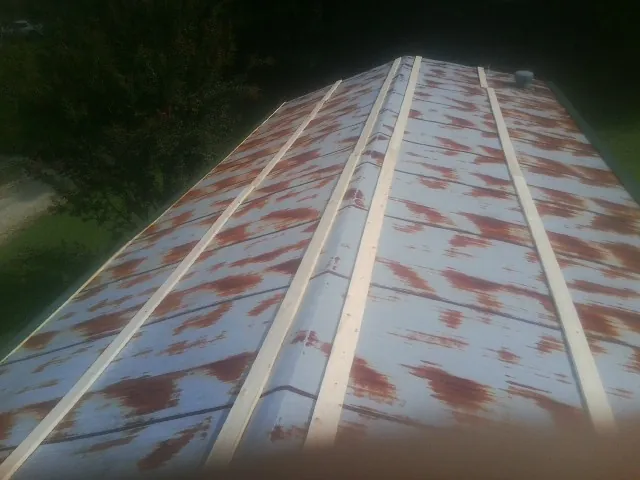 Rusted metal roof panels with new wood purlins before replacement — Storm Damage Roof Repair in Nunda by Roofing Brothers